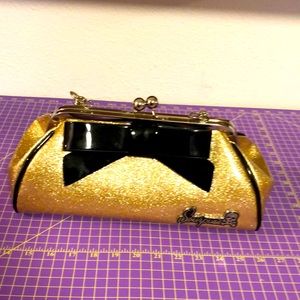 Sour Puss Gold with black bow tie clasp closure leopard satin interior